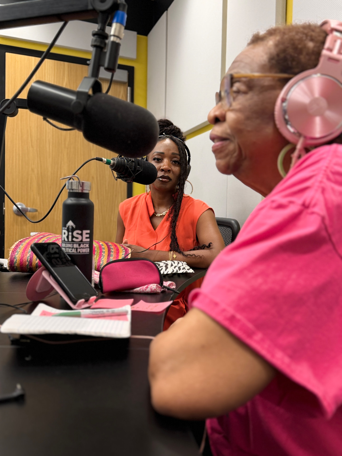 Measure team members recording a community radio conversation