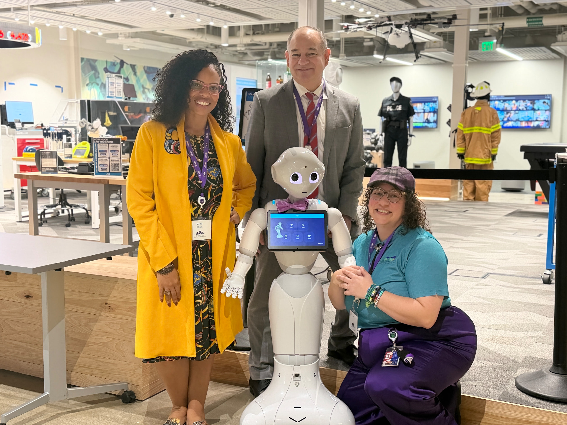 Measure president Meme Styles with partners and a robot at a tech showcase